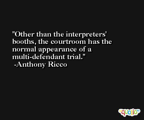 Other than the interpreters' booths, the courtroom has the normal appearance of a multi-defendant trial. -Anthony Ricco